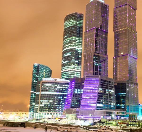 Illuminated city full of modern glass buildings — Stock Photo, Image