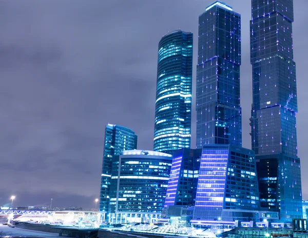 Prospective view to glass high-rise building skyscrapers at nigh — Stock Photo, Image