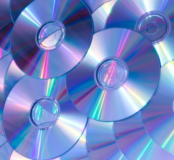 Violette achtergrond van compact discs — Stockfoto