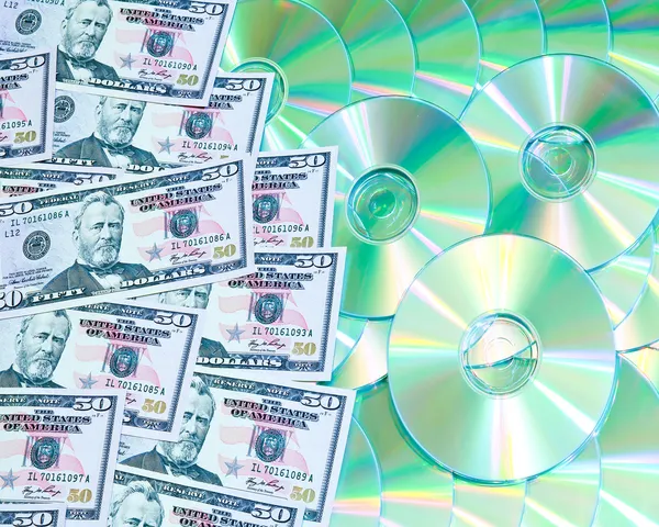 stock image Background of digital discs and money media market concept