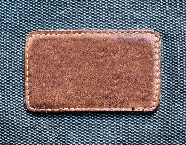 Rectangular leather label isolated over denim texture — Stock Photo, Image
