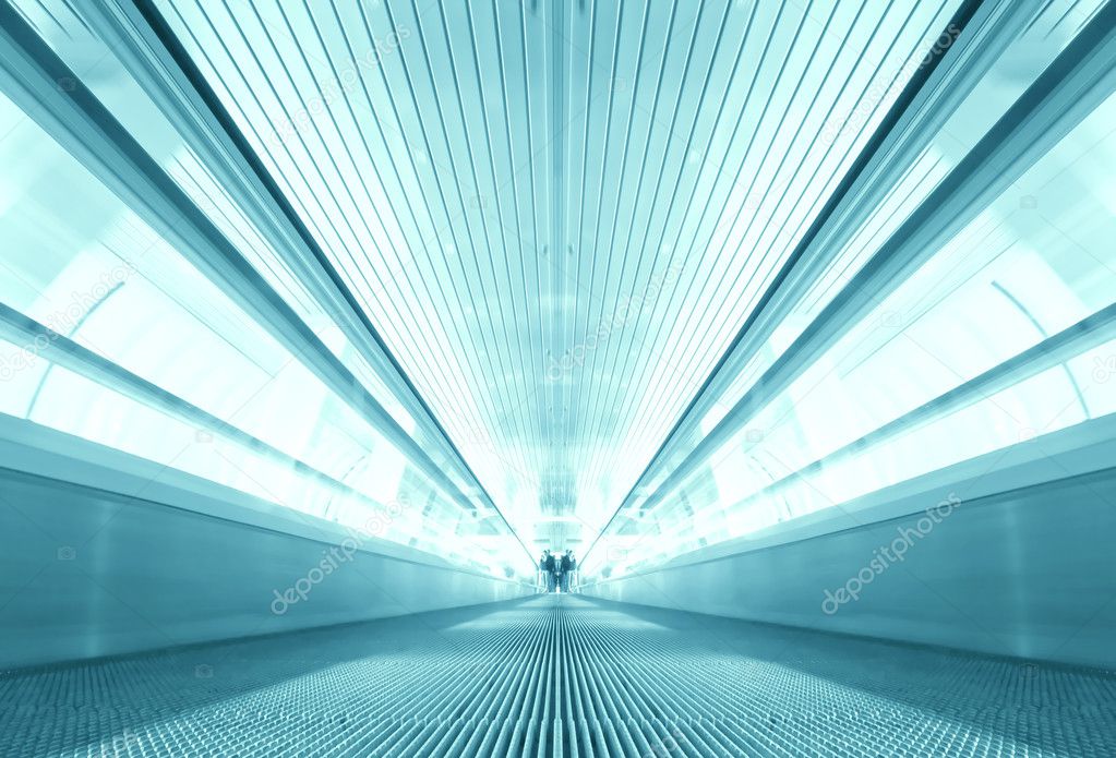 Symmetric moving blue escalator inside contemporary airport