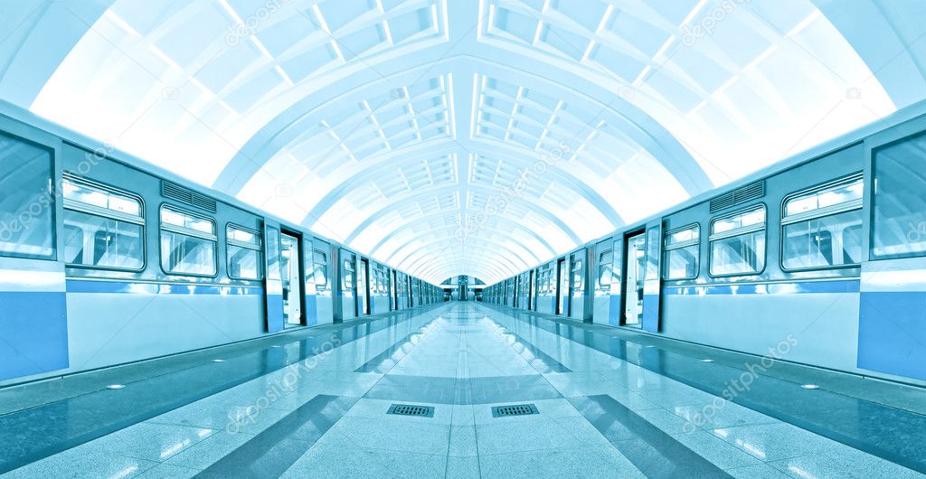 Symmetric illuminated metro station with marble floor