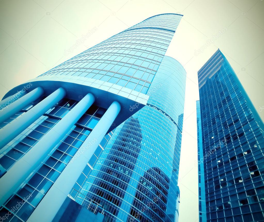 Low angle view to light glass buildings of business center