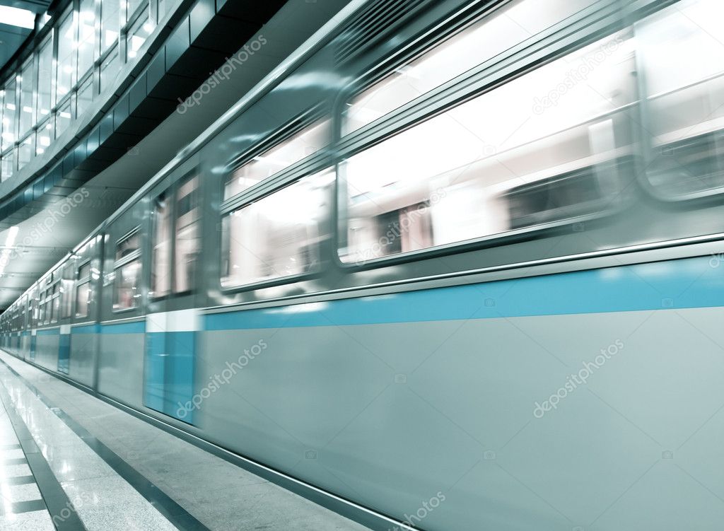 Diminishing blue train leaving the platform