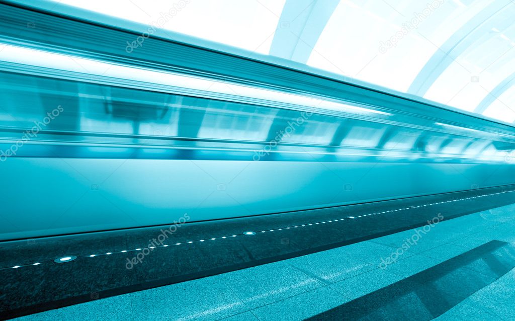 Fast moving train on underground platform