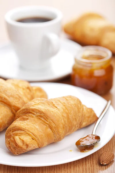 Croissant with jam for breakfast Royalty Free Stock Images