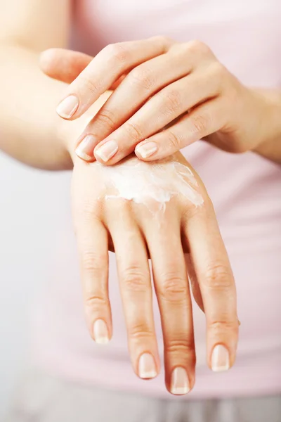 Beautiful woman hands with cream — Stock Photo, Image