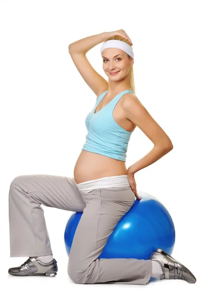 Young pregnant woman making exercise on a fitness ball — Stock Photo, Image