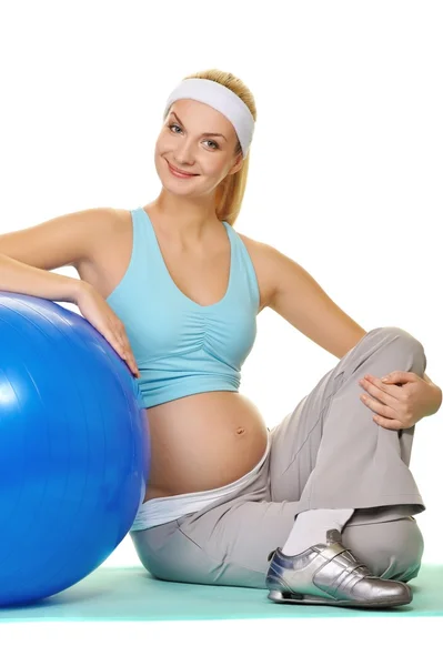Young pregnant woman making exercise with a fitness ball — Stock Photo, Image