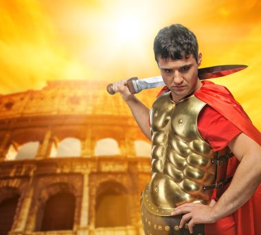 Roman legionary soldier in front of coliseum clipart