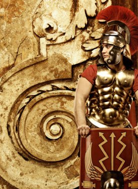 Roman legionary soldier in front of abstract wall clipart