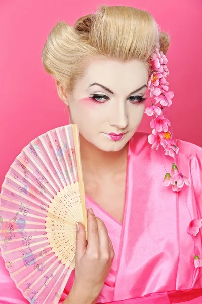 Beautiful geisha with a fan — Stock Photo, Image