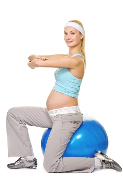 Young pregnant woman making exercise on a fitness ball — Stock Photo, Image