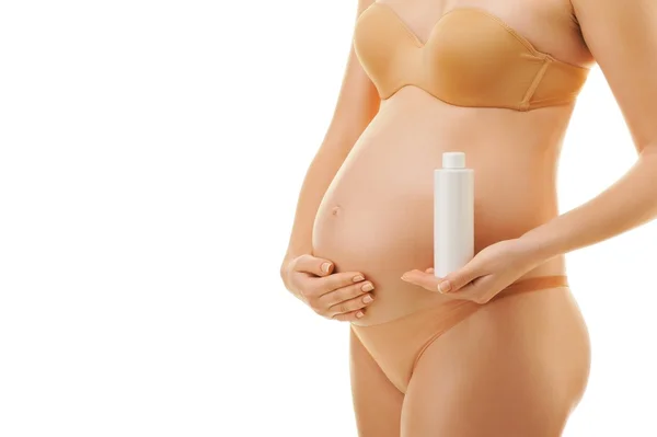 Pregnant woman with a bottle of oil — Stock Photo, Image