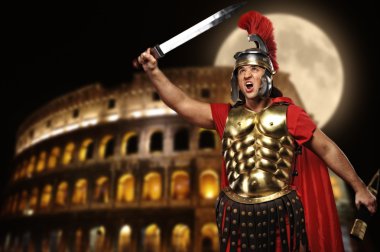 Roman legionary soldier in front of coliseum at night time clipart