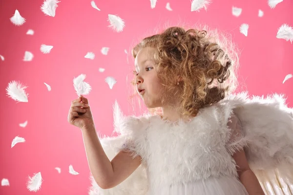 Beautiful angel girl holding a feather Stock Photo