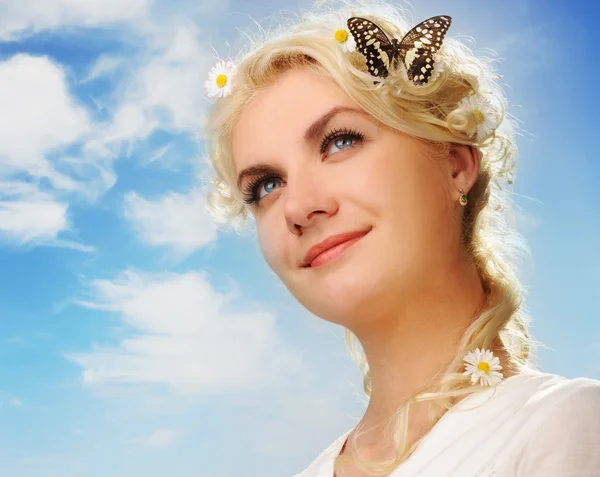 Прекрасна жінка з метеликом над блакитним небом — стокове фото