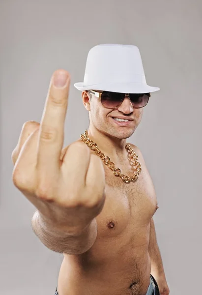 Stylish man in white hat showing middle finger — Stock Photo, Image