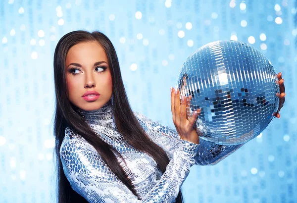 Brunette woman with a disco ball over abstract background — Stock Photo, Image