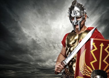 Legionary soldier over stormy sky clipart