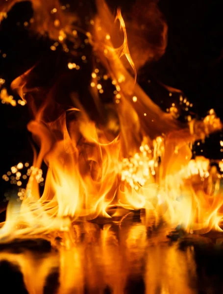 Fire explosion reflected in water — Stock Photo, Image