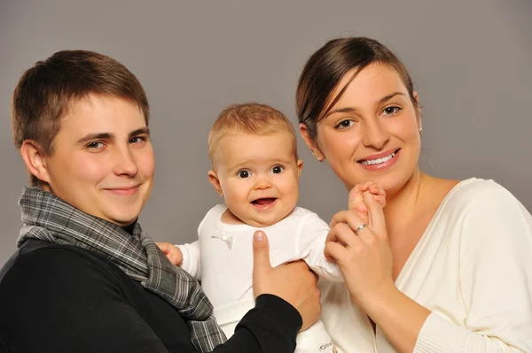 Lyckliga familjen isolerad på grå bakgrund — Stockfoto