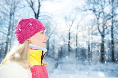 Frozen beautiful woman in winter clothing outdoors clipart