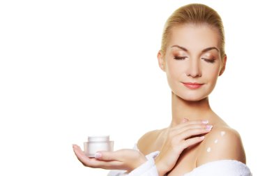 Woman applying moisturizer cream on ner body clipart