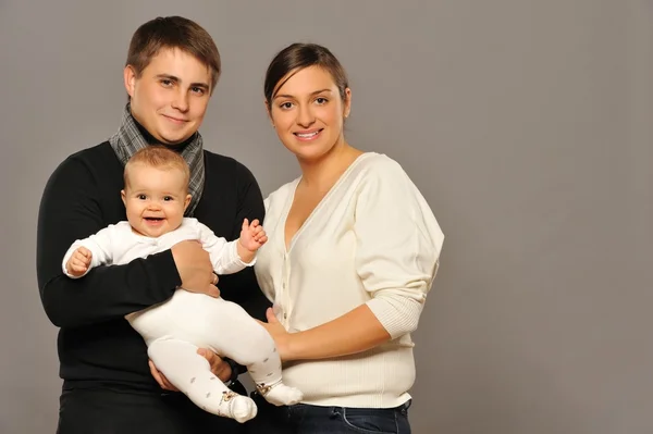 Lyckliga familjen isolerad på grå bakgrund — Stockfoto
