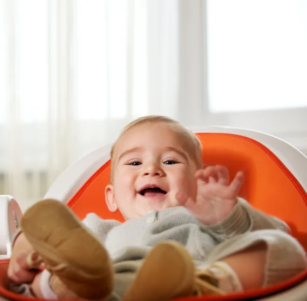 Happy child sitting on a chair — Stock Photo, Image