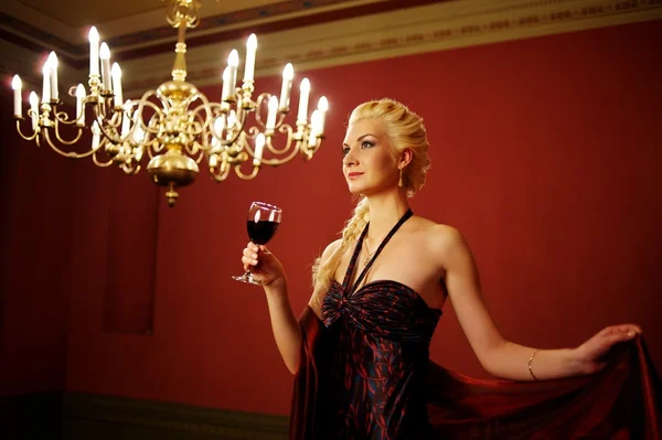 Senhora atraente com um copo de vinho tinto — Fotografia de Stock