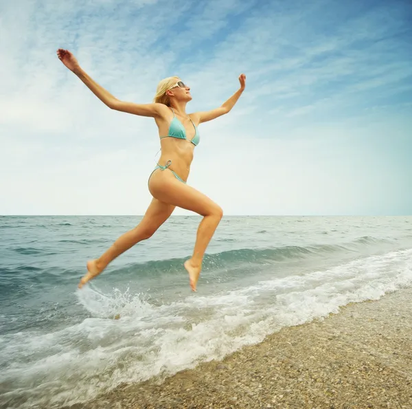 Mulher loira bonita correndo na água — Fotografia de Stock