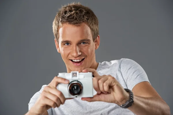 Young man with a camera — Stock Photo, Image