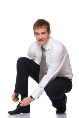 Businessman laces one's shoes clipart