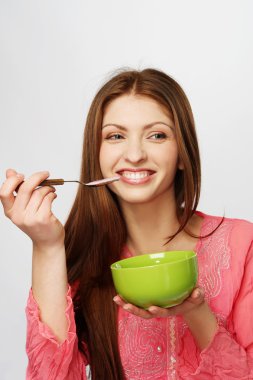 Beautiful brunette woman having a breakfast clipart