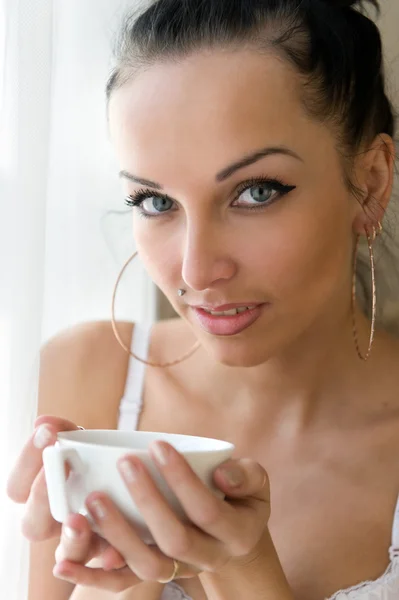 朝。美しい女性は、ウィンドウでお茶を飲んでいます。 — ストック写真