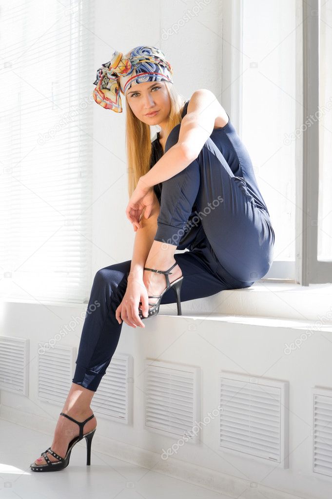 Fashionable blonde at the opened window