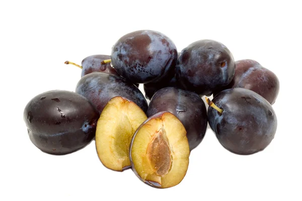 Plums with a sheet and stone are on a white background. — Stock Photo, Image