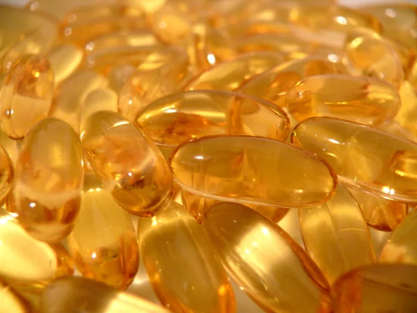 stock image Pills with Fish Oil background