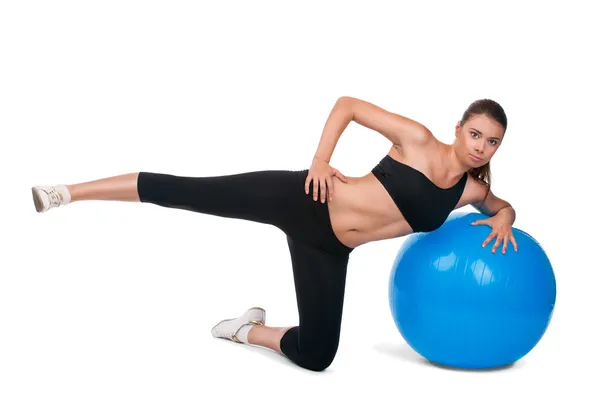 Strong girl excersicing with fitball — Stok fotoğraf