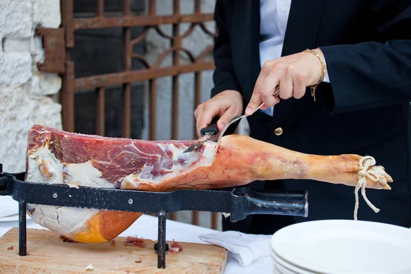 stock image Waiter while slicing jamon