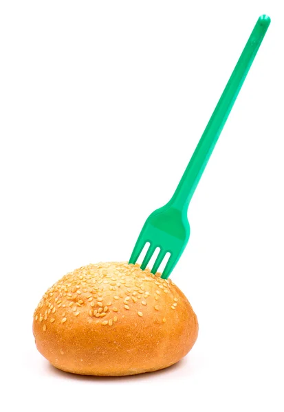 Plastic fork in the bun — Stock Photo, Image