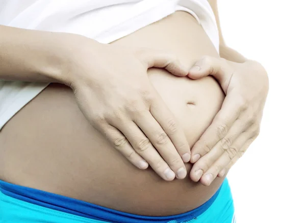 Kobieta w ciąży z opalać brzuch — Zdjęcie stockowe