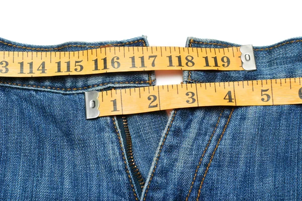 Calça jeans e fita métrica isolada — Fotografia de Stock