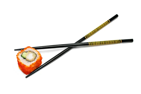 Single japan sushi roll in the chopsticks — Stockfoto