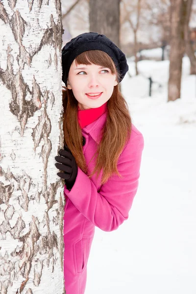 Mujer en un parque de invierno cerca de un abedul —  Fotos de Stock