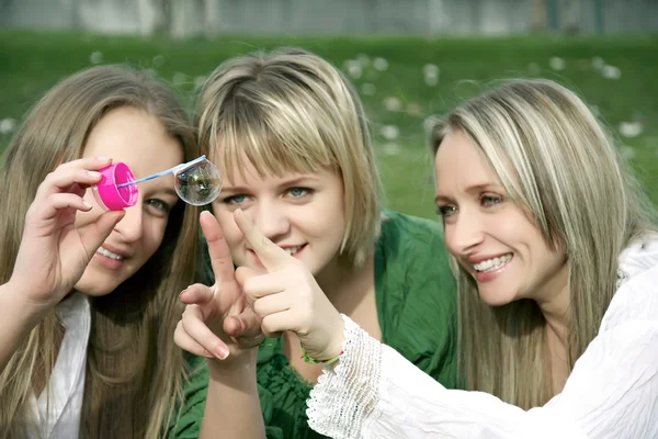 Meninas inflando bolhas de sabão no parque — Fotografia de Stock