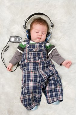 Newborn kid listening music clipart