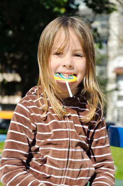 Girl with lollipop Stock Image